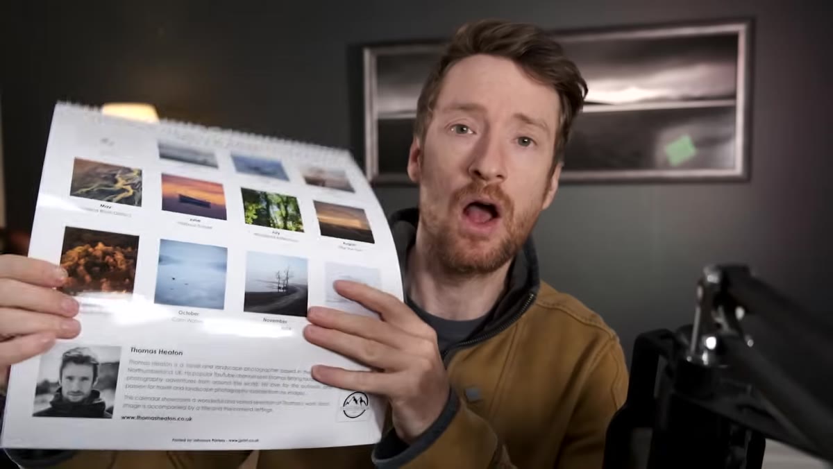Annual calendar product laid out on table next to the photography book