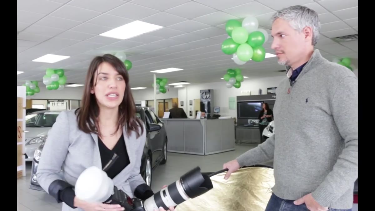 Photographer reviewing a natural light window setup in the office